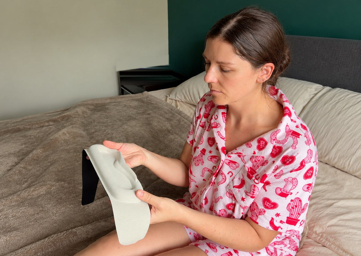 Woman holding the Gravity weighted sleep mask to show its contoured eye cups